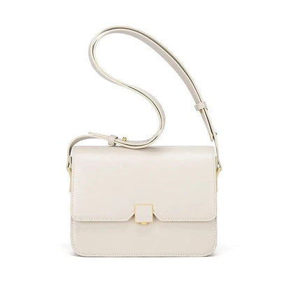 Stylish British-inspired leather shoulder and crossbody bag in black, tan, and navy colours