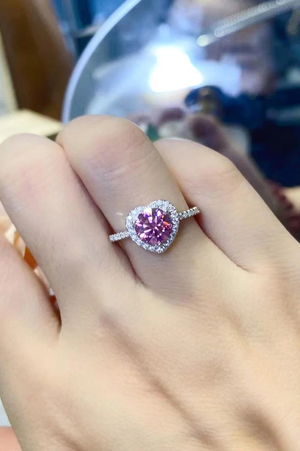 Elegant platinum-plated 925 sterling silver ring featuring a captivating 1 carat moissanite heart-shaped centre stone and sparkling zircon accents.