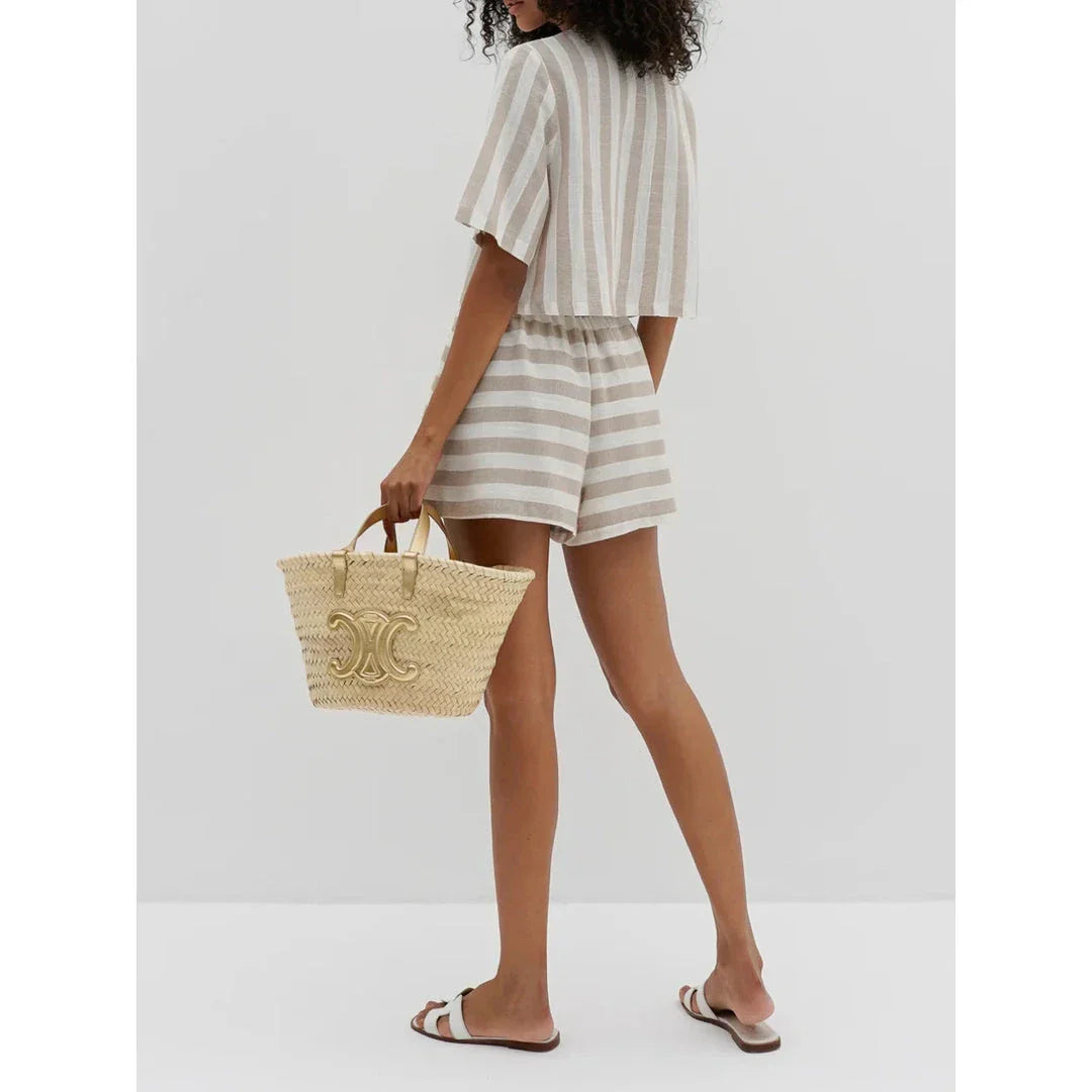 Relaxed and stylish two-piece summer outfit with a striped pattern, featuring a short-sleeved shirt and high-waist shorts.