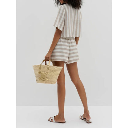 Relaxed and stylish two-piece summer outfit with a striped pattern, featuring a short-sleeved shirt and high-waist shorts.