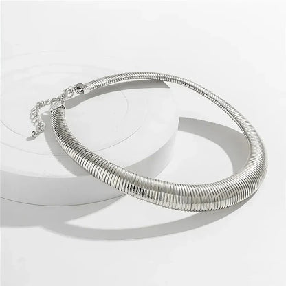 Captivating spiral chunky choker necklace in gold and silver colours, featuring a bold, geometric design for a unique, statement-making look.