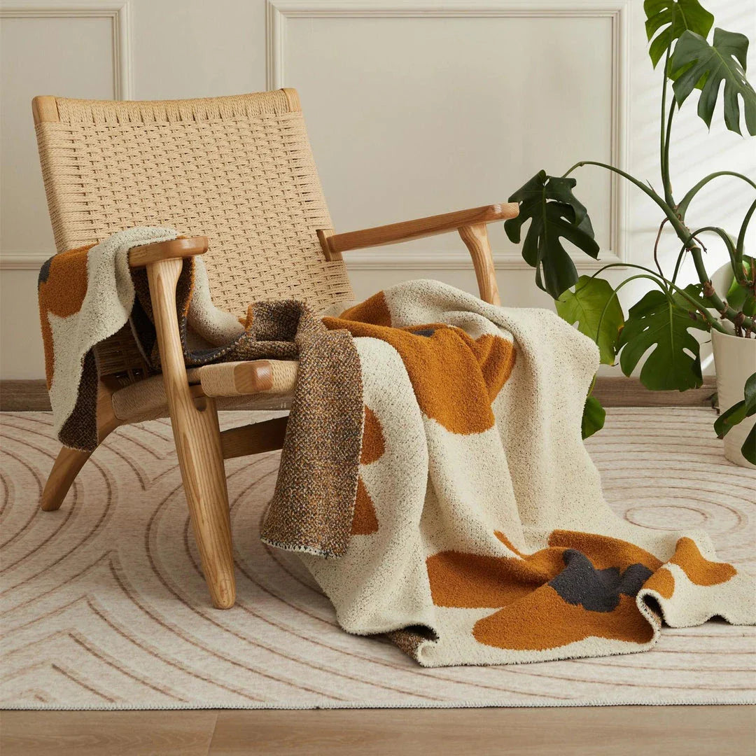 Cosy floral knitted throw blanket in red, featuring a chic bohemian design and luxurious microfibre fabric for maximum comfort and style.