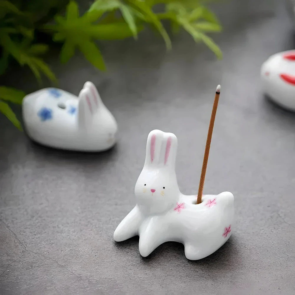 Charming Japanese-style ceramic incense holder with a playful rabbit and kitten design, perfect for creating a relaxing atmosphere in any room.