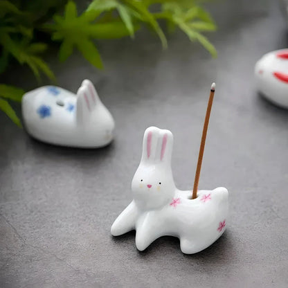 Charming Japanese-style ceramic incense holder with a playful rabbit and kitten design, perfect for creating a relaxing atmosphere in any room.