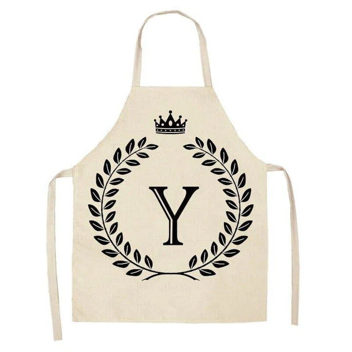 A high-quality kitchen apron featuring a charming crown and letter print design in a premium cotton and linen blend fabric.