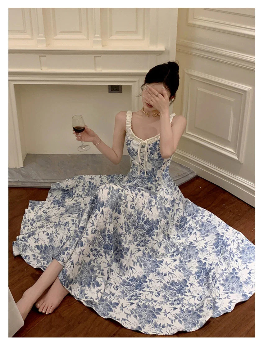 Elegant floral print dress with adjustable straps, A-line silhouette, and high-waisted design for a timeless British fashion look.