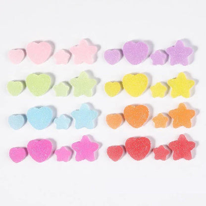 Heart and star-shaped nail charms with candy-inspired designs for creating unique and eye-catching nail art
