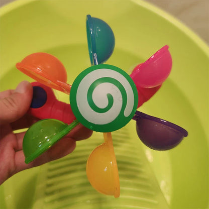Colourful children's bath toy with a turning windmill and spoon for imaginative water play