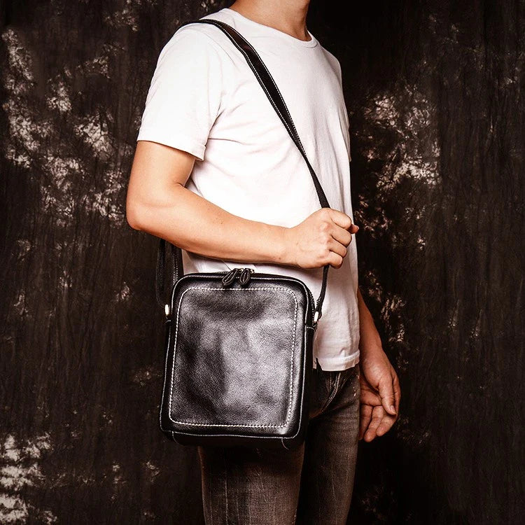 A premium cowhide leather satchel bag with a single shoulder strap, designed for the discerning British gentleman