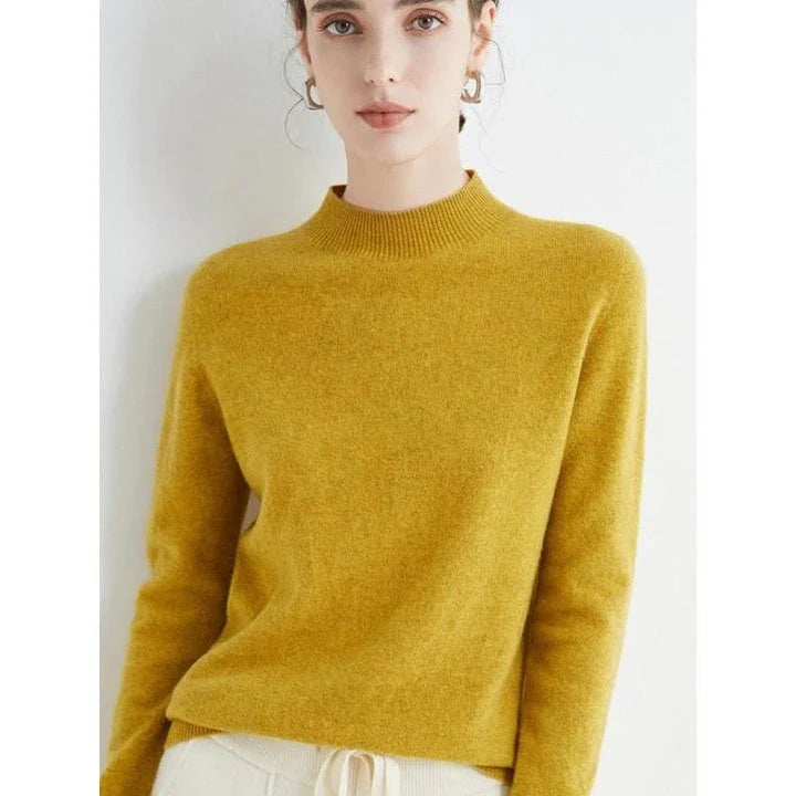 A woman wearing a luxurious Merino wool mock-neck jumper in a stylish autumnal outfit