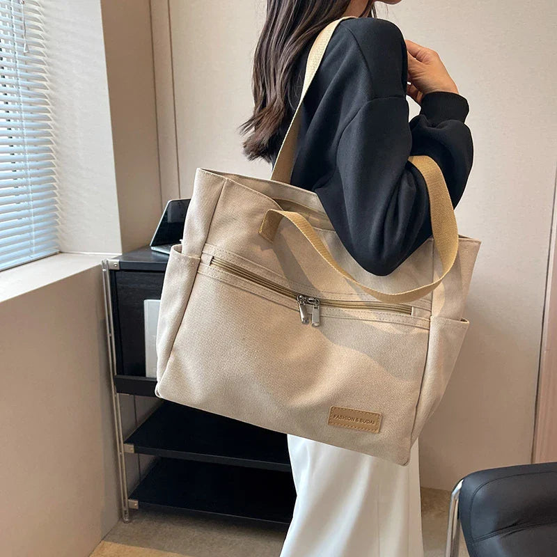 Premium canvas shoulder bag in grey, khaki, and green colours, featuring a stylish and functional design for everyday use.