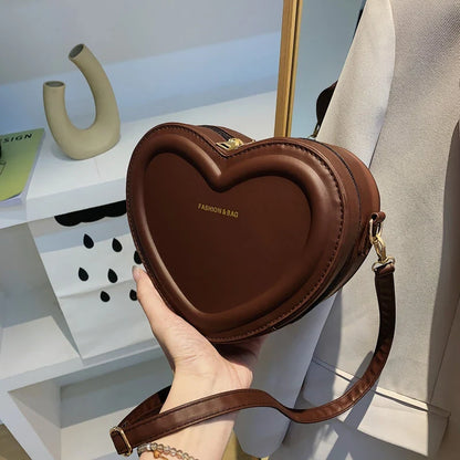 Chic heart-shaped crossbody bag made from premium PU leather, available in multiple stylish colours