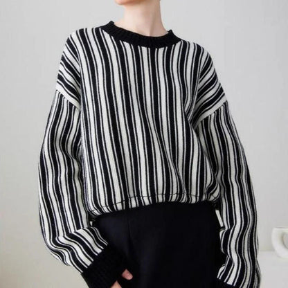 A chic striped wool-blend jumper in black, featuring an elegant O-neck design and a relaxed, flattering fit