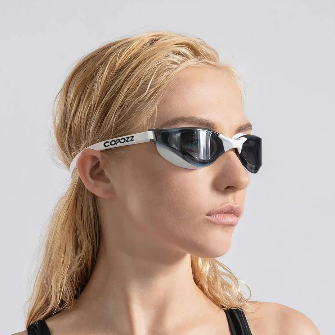 Premium British-made swimming goggles with anti-fog and UV protection technology, designed for clear visibility and comfort in pools, beaches, and water parks.