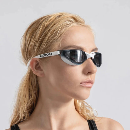 Premium British-made swimming goggles with anti-fog and UV protection technology, designed for clear visibility and comfort in pools, beaches, and water parks.