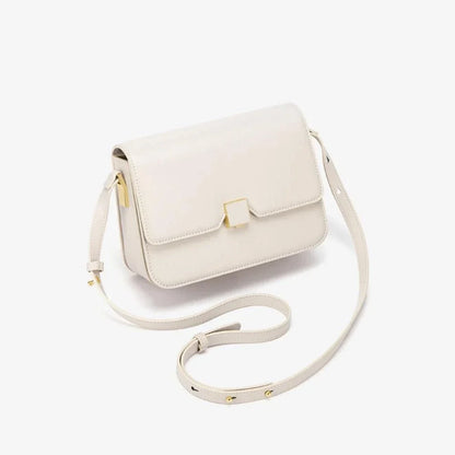 Stylish British-inspired leather shoulder and crossbody bag in black, tan, and navy colours