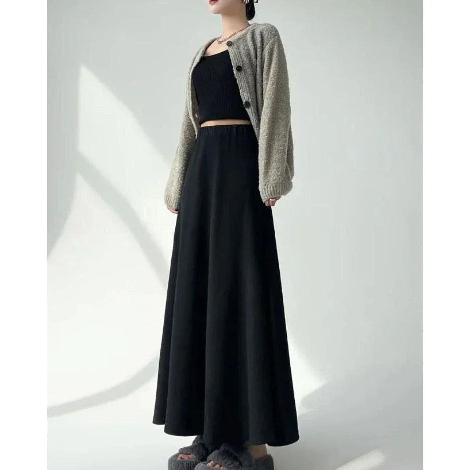 Elegant high-waist knitted skirt in black, showcasing a flattering A-line silhouette and ankle-length cut for the modern British woman.