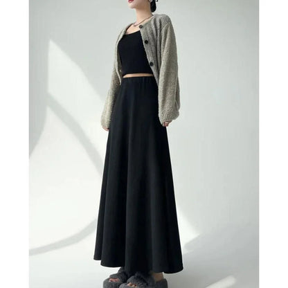 Elegant high-waist knitted skirt in black, showcasing a flattering A-line silhouette and ankle-length cut for the modern British woman.