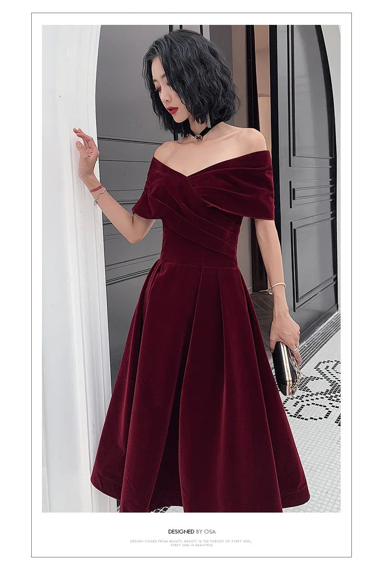 Off-shoulder wine red bridal dress with long, flowing skirt and tight waist for a sophisticated, elegant look