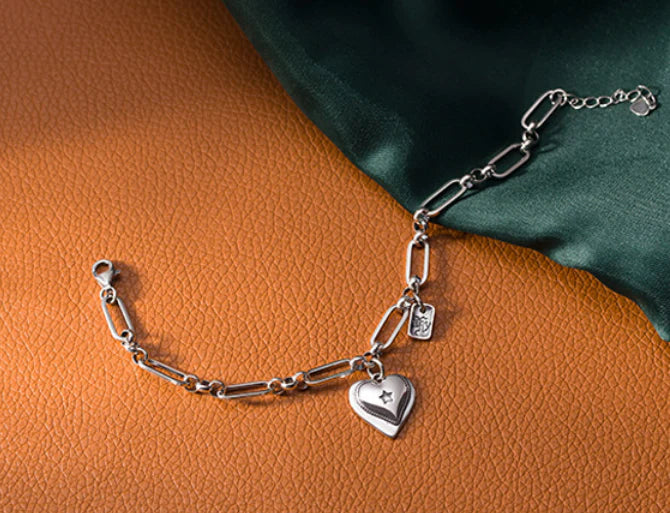 Elegant sterling silver bracelet with a delicate heart charm, a timeless accessory for the modern British woman.