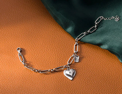 Elegant sterling silver bracelet with a delicate heart charm, a timeless accessory for the modern British woman.