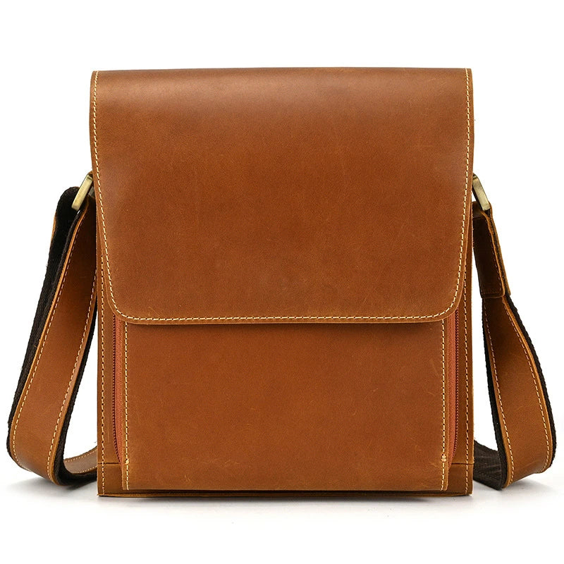 Premium leather crossbody bag with flap closure, vertical square shape, and multiple interior compartments