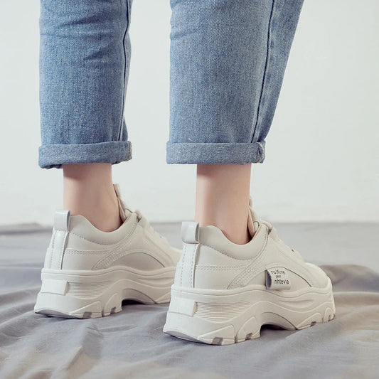 Fashionable women's casual trainers in beige and white colours, featuring a sporty yet chic design for everyday wear.