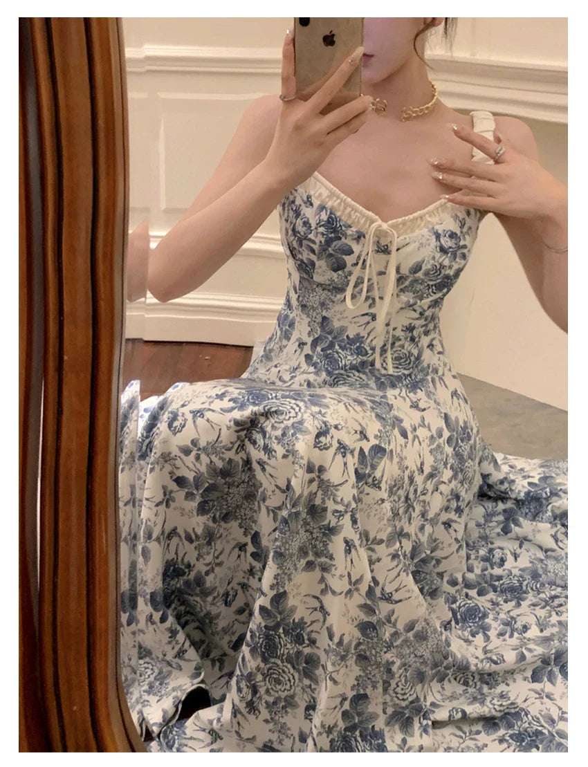 Elegant floral print dress with adjustable straps, A-line silhouette, and high-waisted design for a timeless British fashion look.