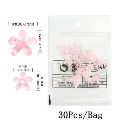 Elegant 3D flower nail charms in white and pink colours, featuring a transparent jelly finish and rhinestone accents for a stylish manicure