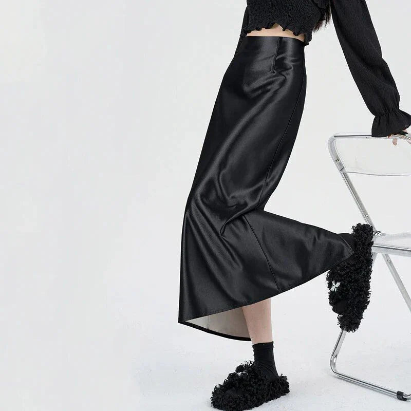 Luxurious silver satin maxi skirt with high-waist design and chic back split for elegant and versatile style.