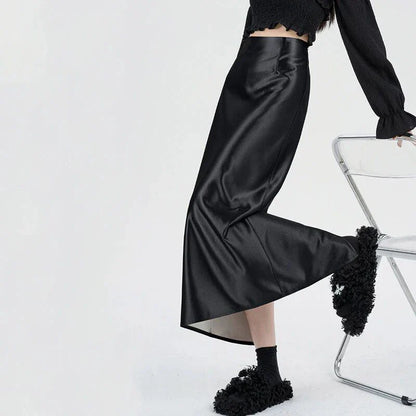 Luxurious silver satin maxi skirt with high-waist design and chic back split for elegant and versatile style.
