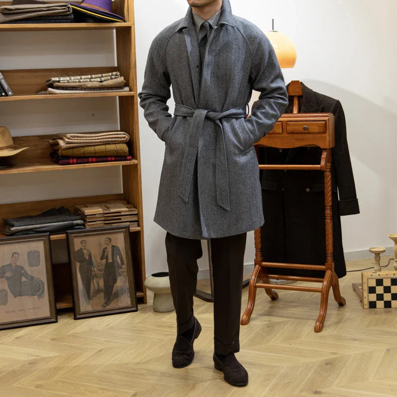 Premium mid-length herringbone wool coat in a sophisticated dark grey hue, featuring a tailored slim-fit silhouette for a refined, stylish appearance.