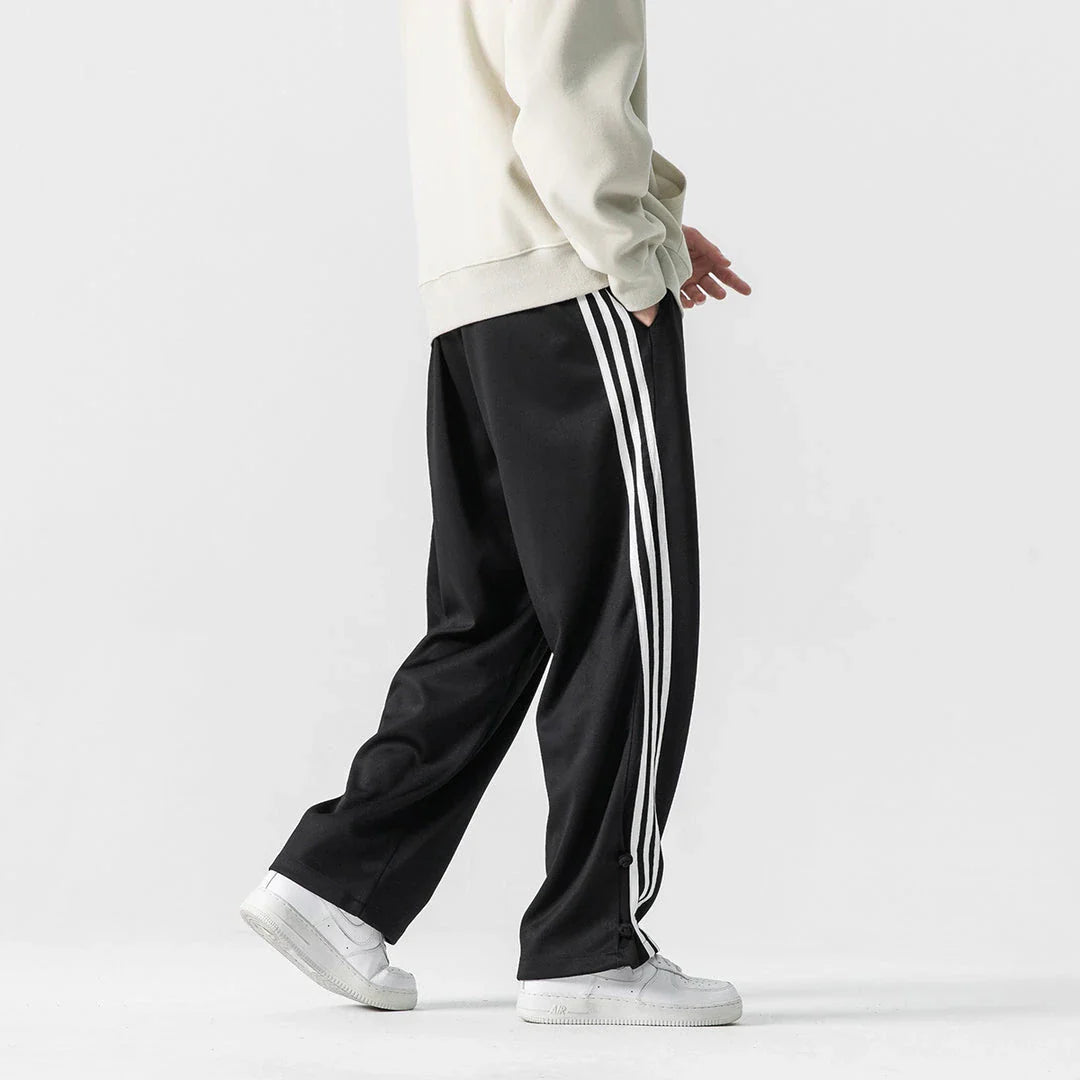 Stylish striped sports trousers in a relaxed, mid-waist design for versatile leisure and athletic wear