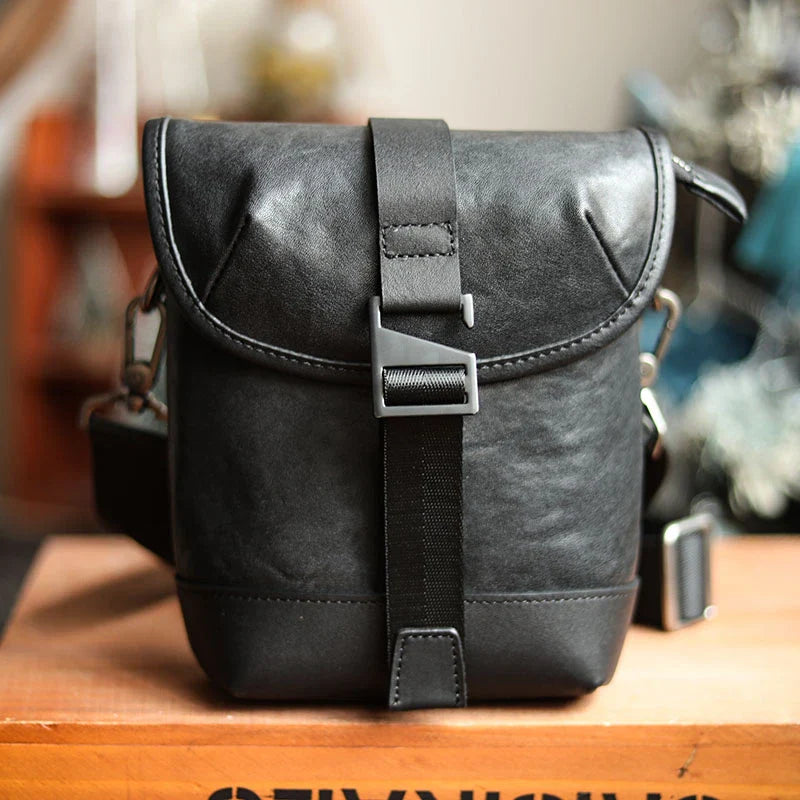 Premium cowhide leather shoulder sling bag with one-shoulder design and oblique paneling for modern British style