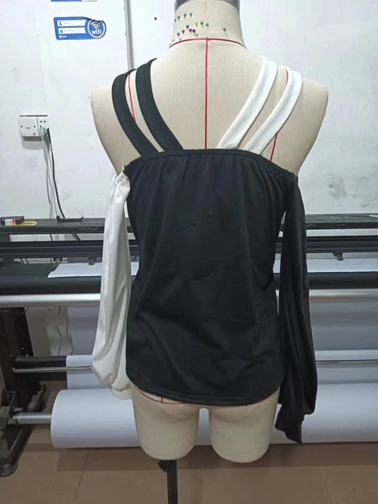 Premium patchwork blouse in black with a unique collage/splicing design, made from high-quality polyester for versatile style and comfort.