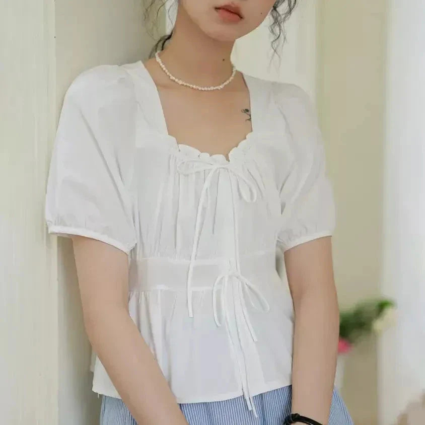 Elegant vintage square neck puff sleeve blouse in white with lace-up detail and puff sleeves
