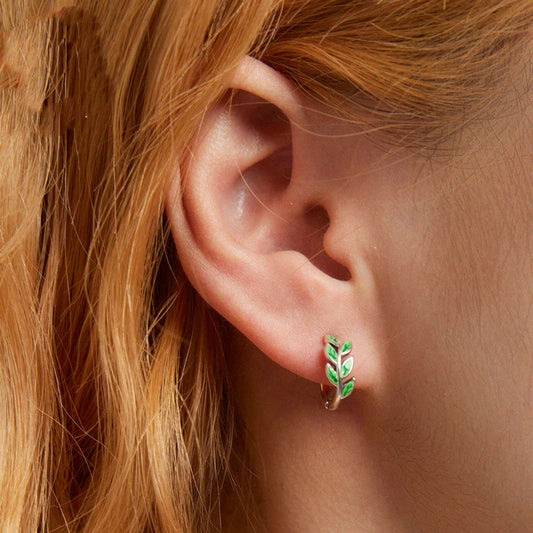 Elegant silver earrings with a fern-inspired design and sparkling green zircon centerpiece