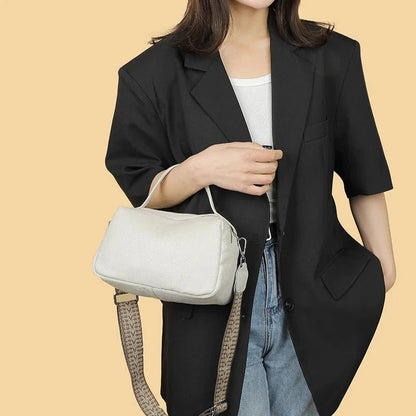 Luxurious genuine leather crossbody bag for women, featuring a soft polyester lining, dual phone pockets, and a compact, square design.