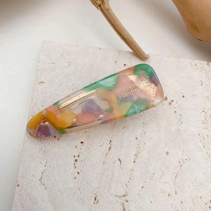 Two marble-patterned hair clips in a contemporary geometric design, made from high-quality acetate and acrylic materials.