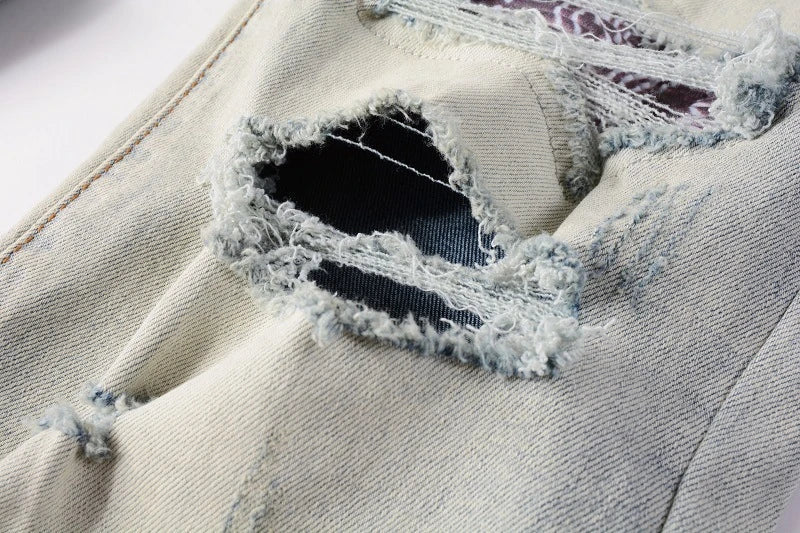 Stylish distressed denim jeans with a skinny, knee-exposed silhouette for a contemporary, high-street fashion look