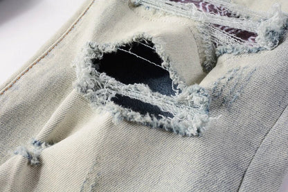 Stylish distressed denim jeans with a skinny, knee-exposed silhouette for a contemporary, high-street fashion look