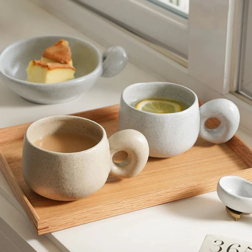 Handcrafted Japanese ceramic retro coffee mug in solid apricot or grey colour, featuring a comfortable handgrip design for enhanced daily beverage enjoyment.