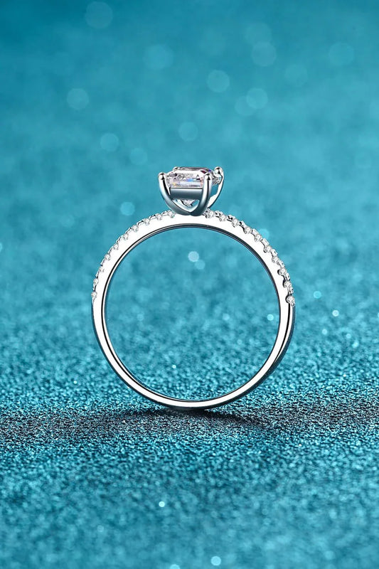 Exquisite 925 sterling silver ring with a radiant moissanite centre stone, accented with sparkling zircon stones for added elegance.