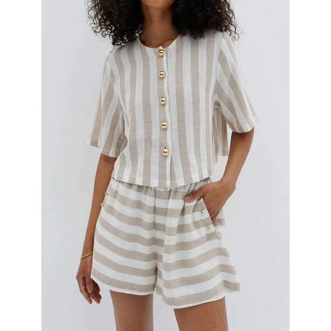 Relaxed and stylish two-piece summer outfit with a striped pattern, featuring a short-sleeved shirt and high-waist shorts.