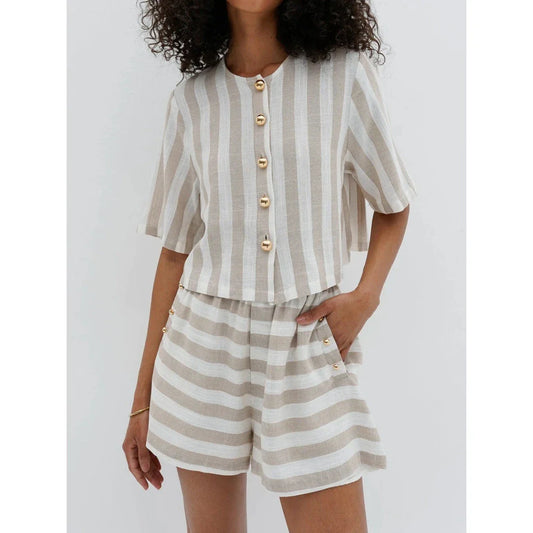 Relaxed and stylish two-piece summer outfit with a striped pattern, featuring a short-sleeved shirt and high-waist shorts.