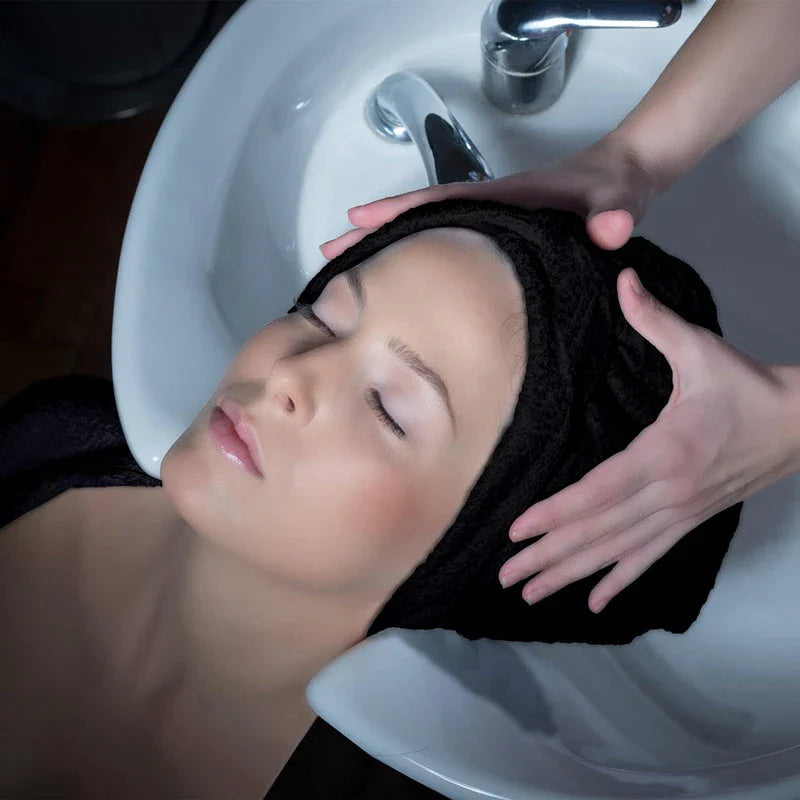 Premium microfibre salon towels in black, featuring a large size, lightweight and highly absorbent design for efficient hair drying