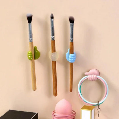Hand-shaped silicone hooks in blue colour, used to organise desks, bathrooms, and cars