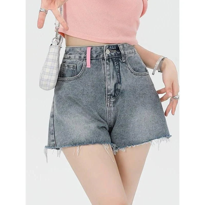 Stylish high-waisted denim shorts with subtle embroidery, perfect for summer fashion