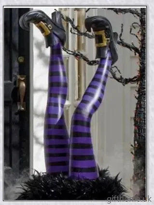 Animated witch legs in various colours, including purple, yellow, and black and white, kicking and moving to create a spooky Halloween display