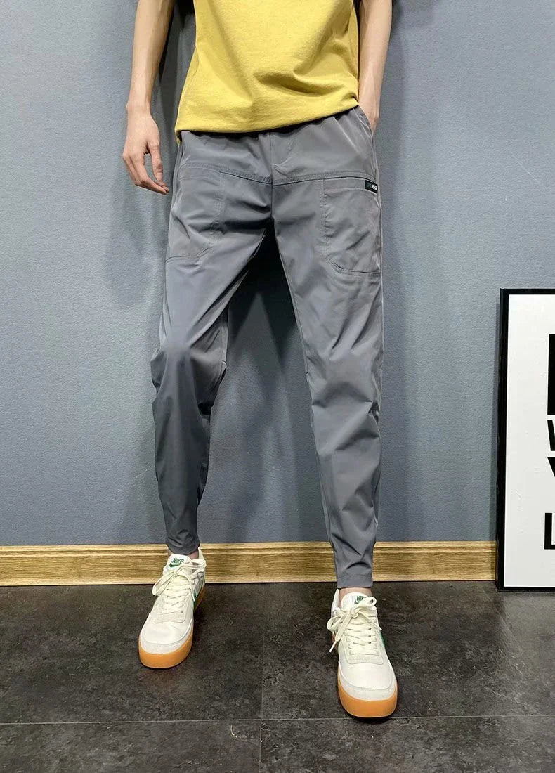 Premium slim-fit drawstring joggers in black and grey, featuring a tailored silhouette and adjustable waistband for a polished, comfortable look.